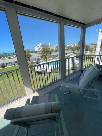 a view of a balcony with furniture and city view