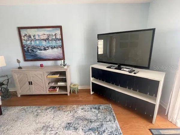 a living room with a flat screen tv and rug