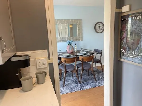 a view of a dining room with a table and chairs