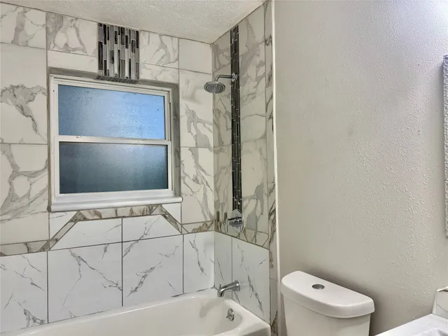 a bathroom with a bathtub and toilet