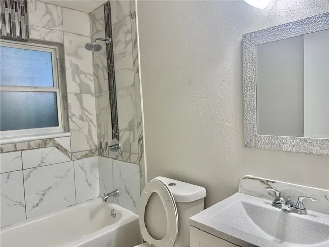 a bathroom with a toilet sink and bathtub