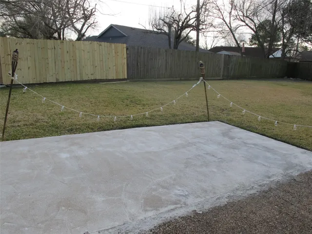 a backyard of a house with a table and chairs