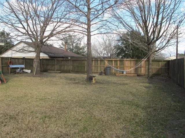 a backyard of a house with table and chairs