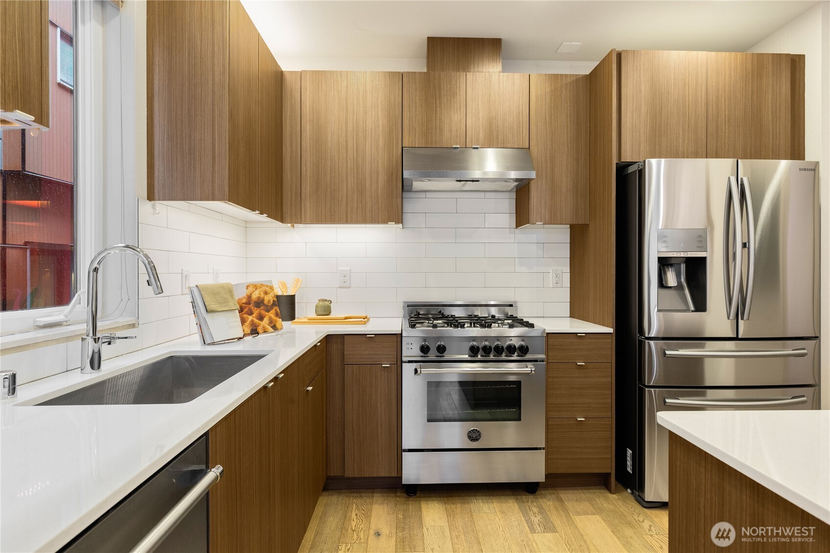 4272 Southwest Bradford Street Seattle, WA 98116 - Photo 12 of 28 a kitchen with stainless steel appliances a stove a sink and a refrigerator