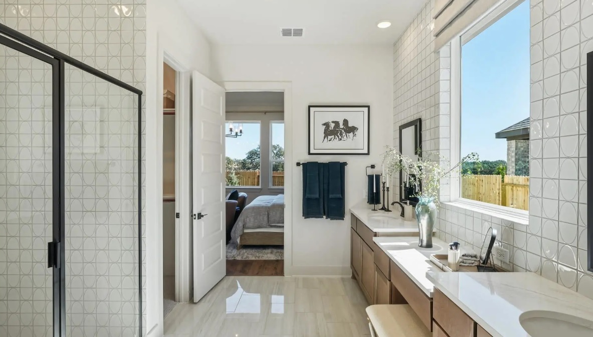 248 Prickly Poppy Way Georgetown, TX 78633 - Photo 7 of 21 Natural light floods this primary bathroom featuring a spacious double vanity and modern shower.