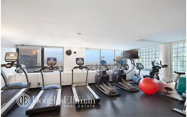 a living room with furniture a couch and a window