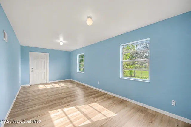a view of a bedroom with window and bed