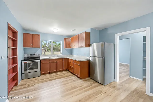 a kitchen with stainless steel appliances granite countertop a refrigerator stove and oven