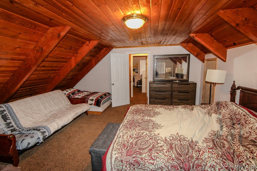 533 Victoria Lane Sugarloaf, CA 92386 - Photo 25 of 36 a bed sitting in a bedroom next to a window