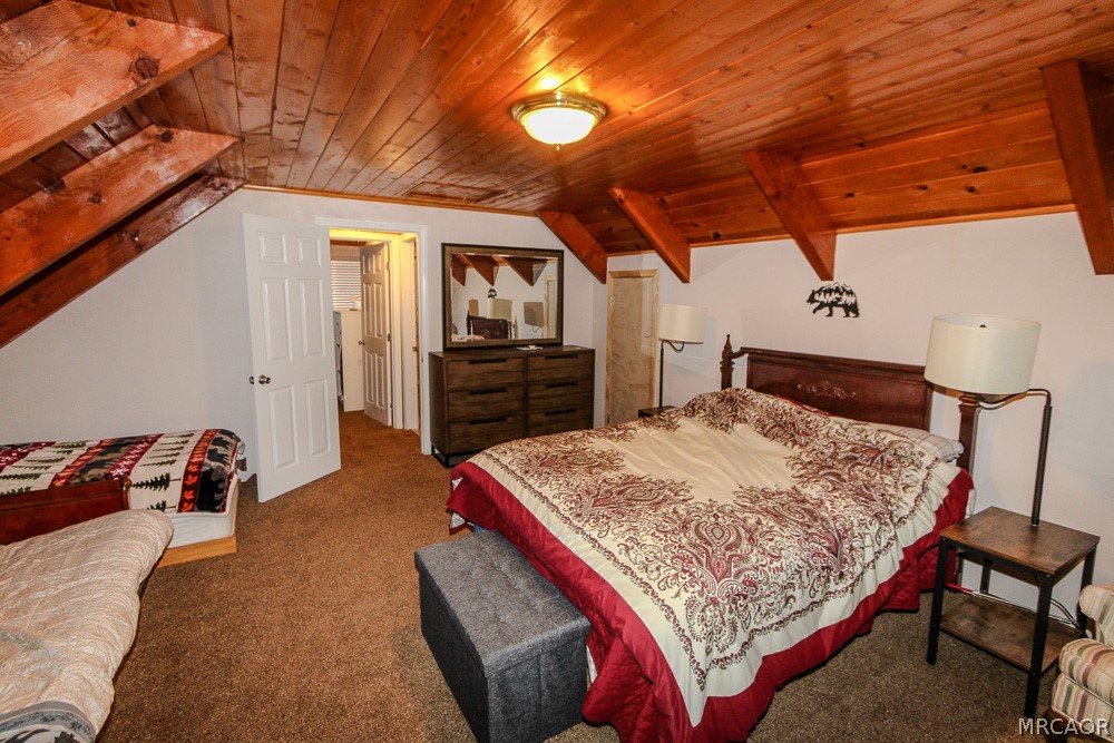 533 Victoria Lane Sugarloaf, CA 92386 - Photo 26 of 36 a bed sitting in a bedroom next to a window