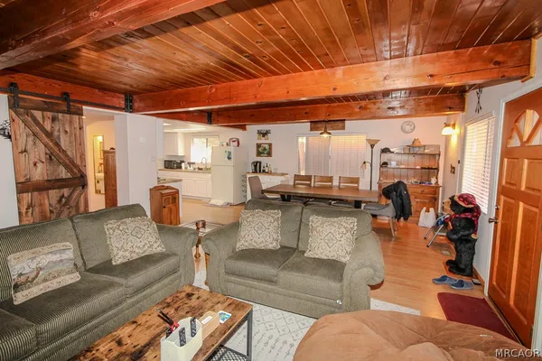 a living room with furniture and a chandelier