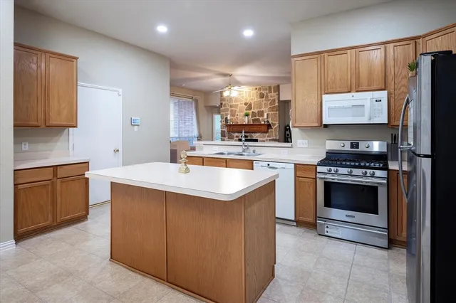 a kitchen with a sink stove top oven and cabinets
