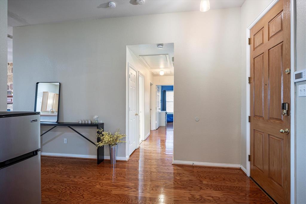 7906 Munich Drive Rowlett, TX 75088 - Photo 14 of 31 a view of a hallway with wooden floor and furniture