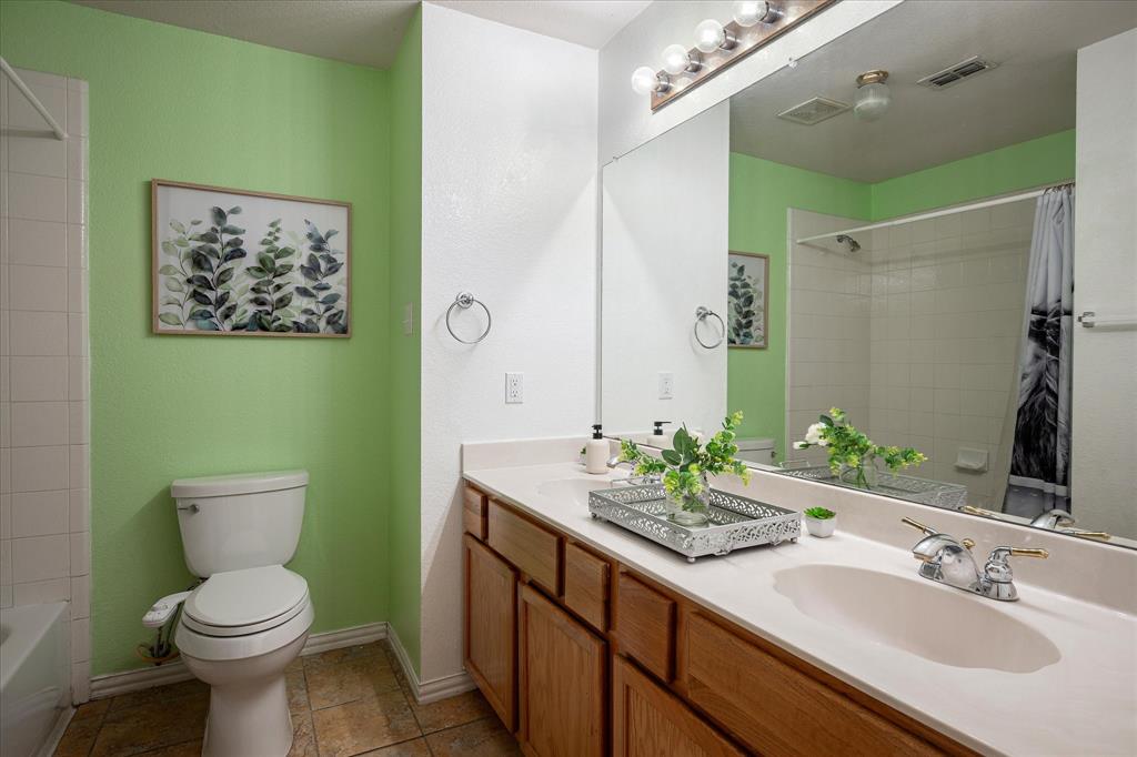 7906 Munich Drive Rowlett, TX 75088 - Photo 20 of 31 a bathroom with a toilet sink and mirror