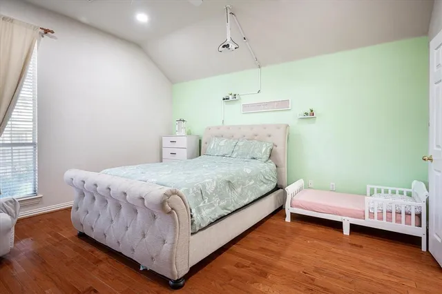 a bedroom with a bed and a night stand