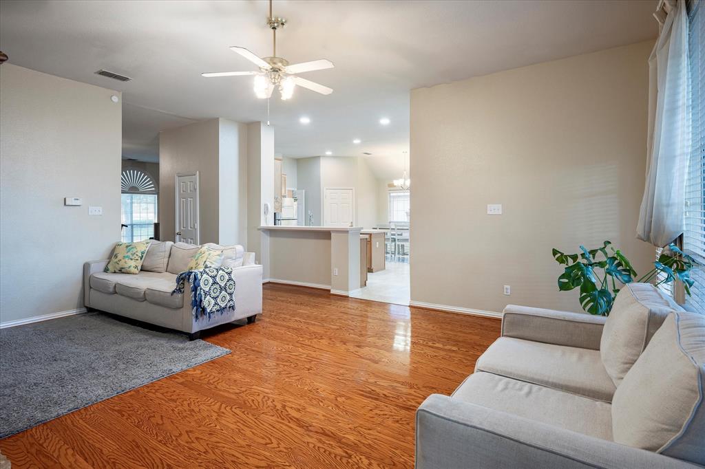 7906 Munich Drive Rowlett, TX 75088 - Photo 10 of 31 a living room with furniture and a chandelier