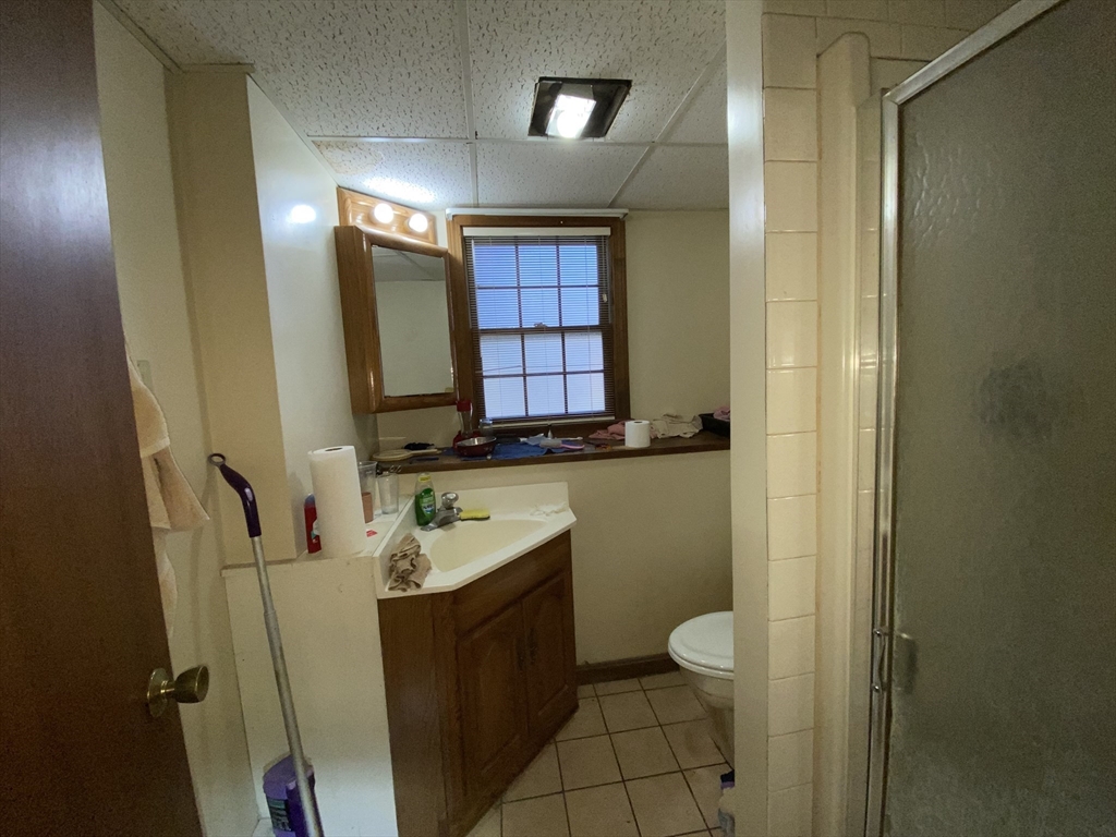 571 Ware Street Mansfield, MA 02048 - Photo 13 of 20 a bathroom with a granite countertop sink and a mirror