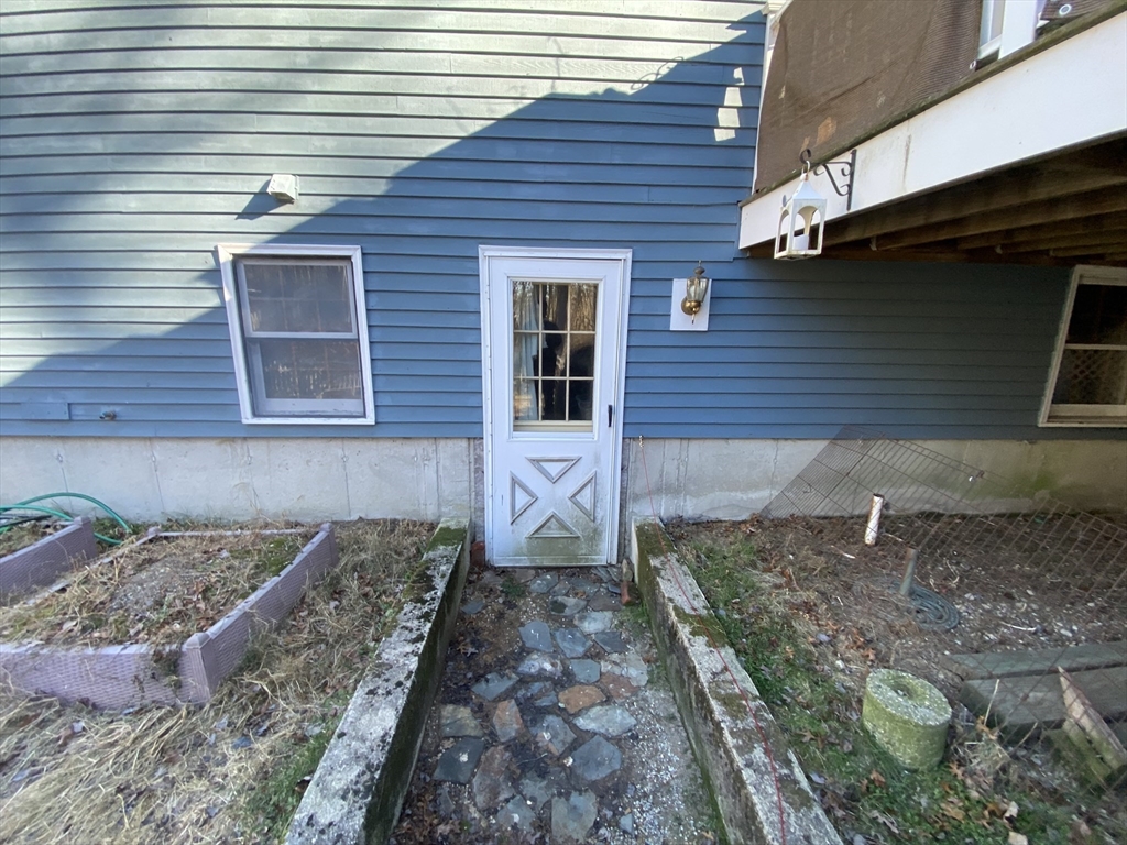 571 Ware Street Mansfield, MA 02048 - Photo 17 of 20 a front view of a house with a wooden fence