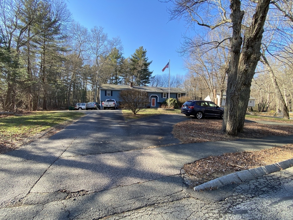 571 Ware Street Mansfield, MA 02048 - Photo 4 of 20 a view of a yard with cars parked on the road