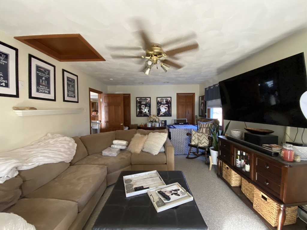 571 Ware Street Mansfield, MA 02048 - Photo 5 of 20 a living room with furniture and a flat screen tv