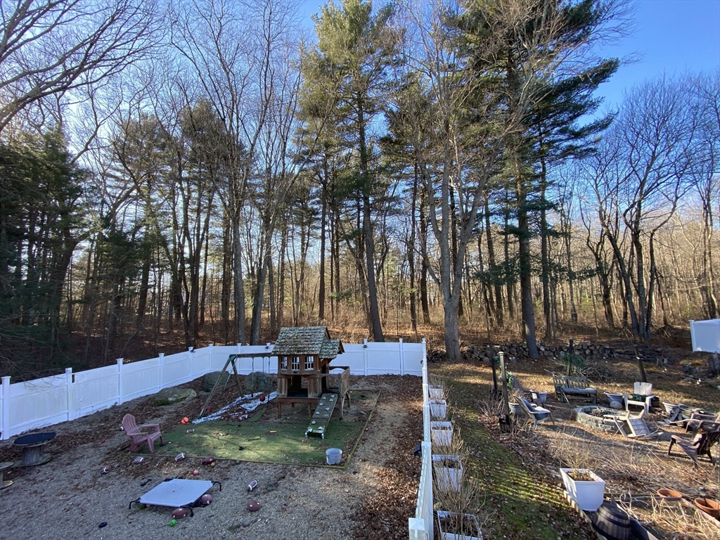 571 Ware Street Mansfield, MA 02048 - Photo 8 of 20 a backyard of a house with table and chairs