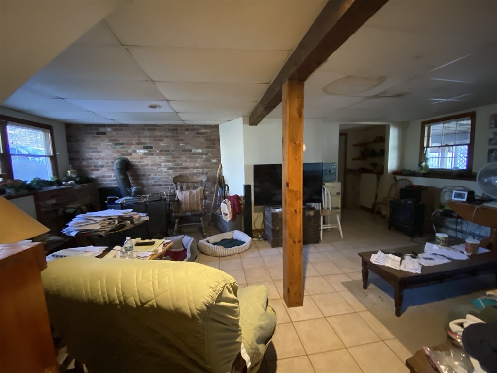 571 Ware Street Mansfield, MA 02048 - Photo 9 of 20 a bed room with furniture and a fireplace