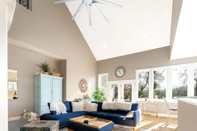 a living room with lots of furniture and view of kitchen