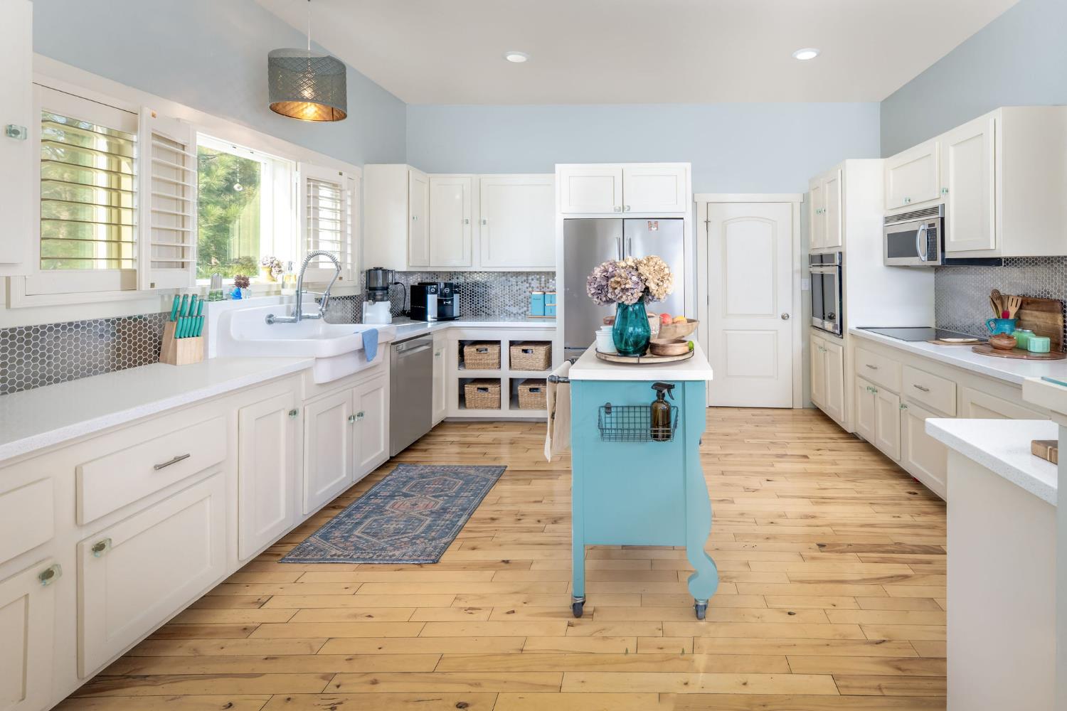 13579 Haas Court Rough and Ready, CA 95975 - Photo 2 of 79 a large white kitchen with cabinets and wooden floor