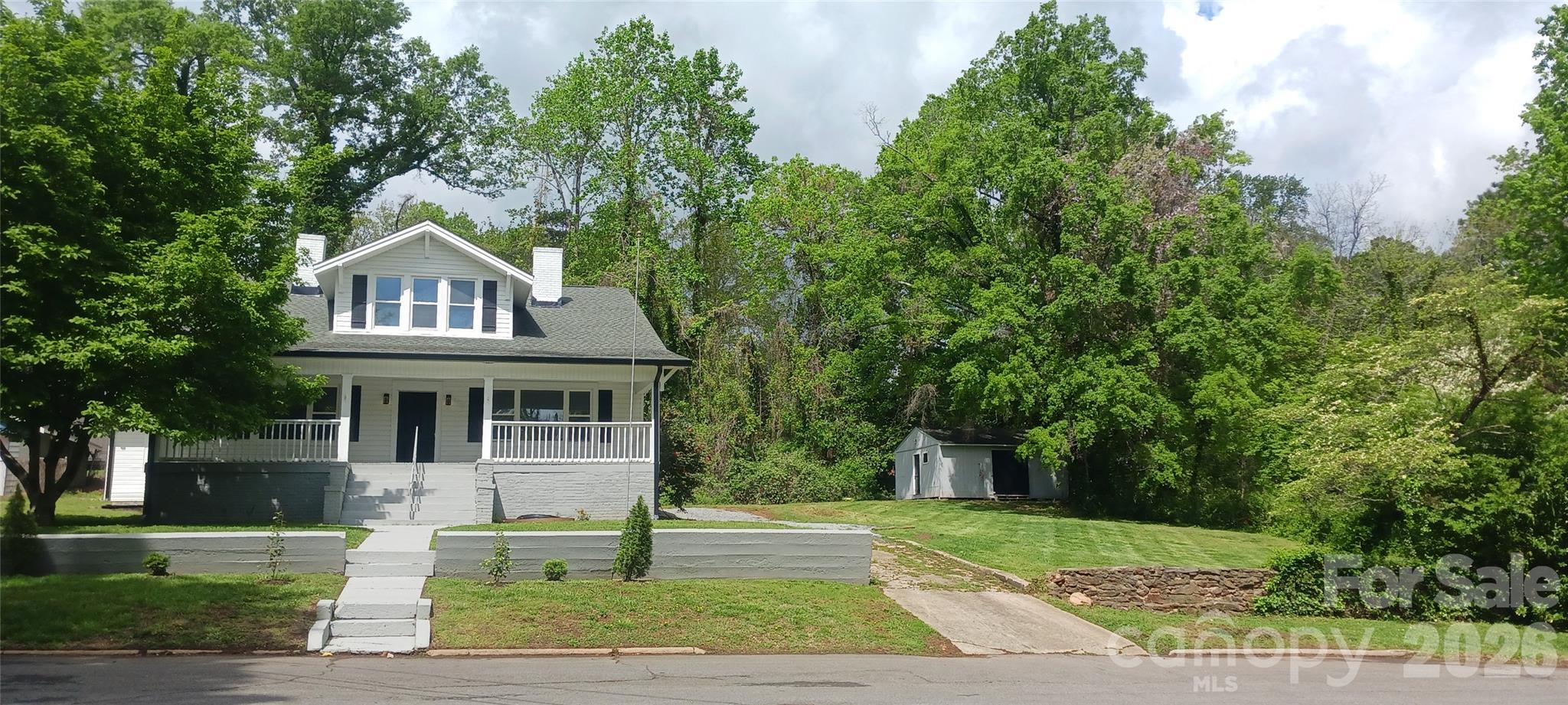 105 North Inman Avenue Bessemer City, NC 28016 - Photo 1 of 38 a front view of a house with a garden