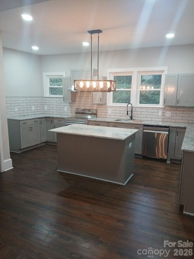 105 North Inman Avenue Bessemer City, NC 28016 - Photo 11 of 38 a kitchen with stainless steel appliances granite countertop a sink stove and wooden floor