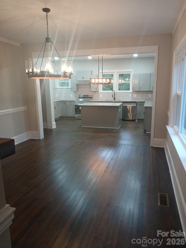 105 North Inman Avenue Bessemer City, NC 28016 - Photo 12 of 38 a kitchen with stainless steel appliances wooden floors and view living room