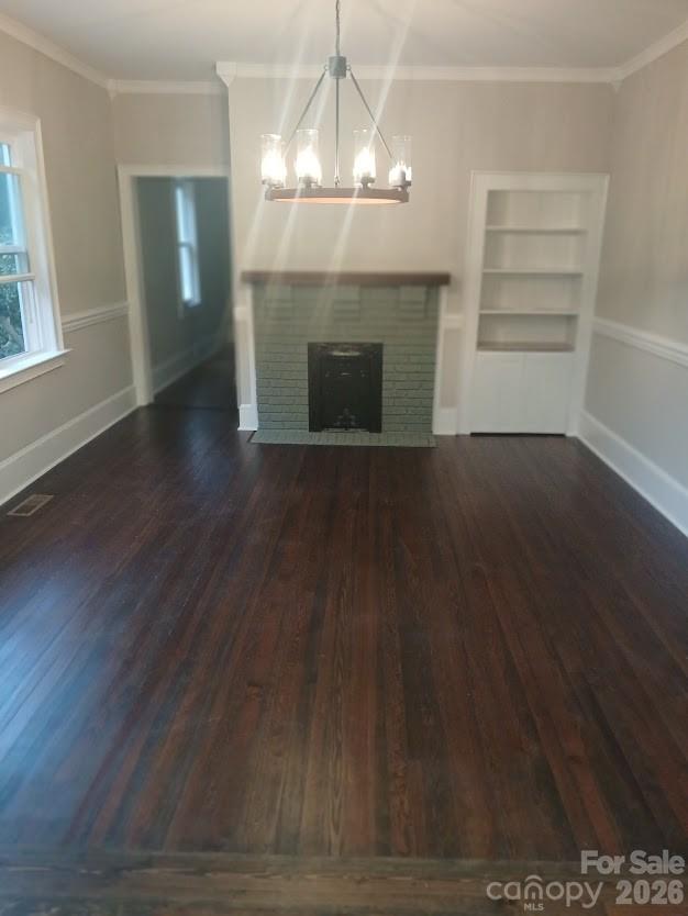 105 North Inman Avenue Bessemer City, NC 28016 - Photo 14 of 38 an empty room with wooden floor fireplace and window