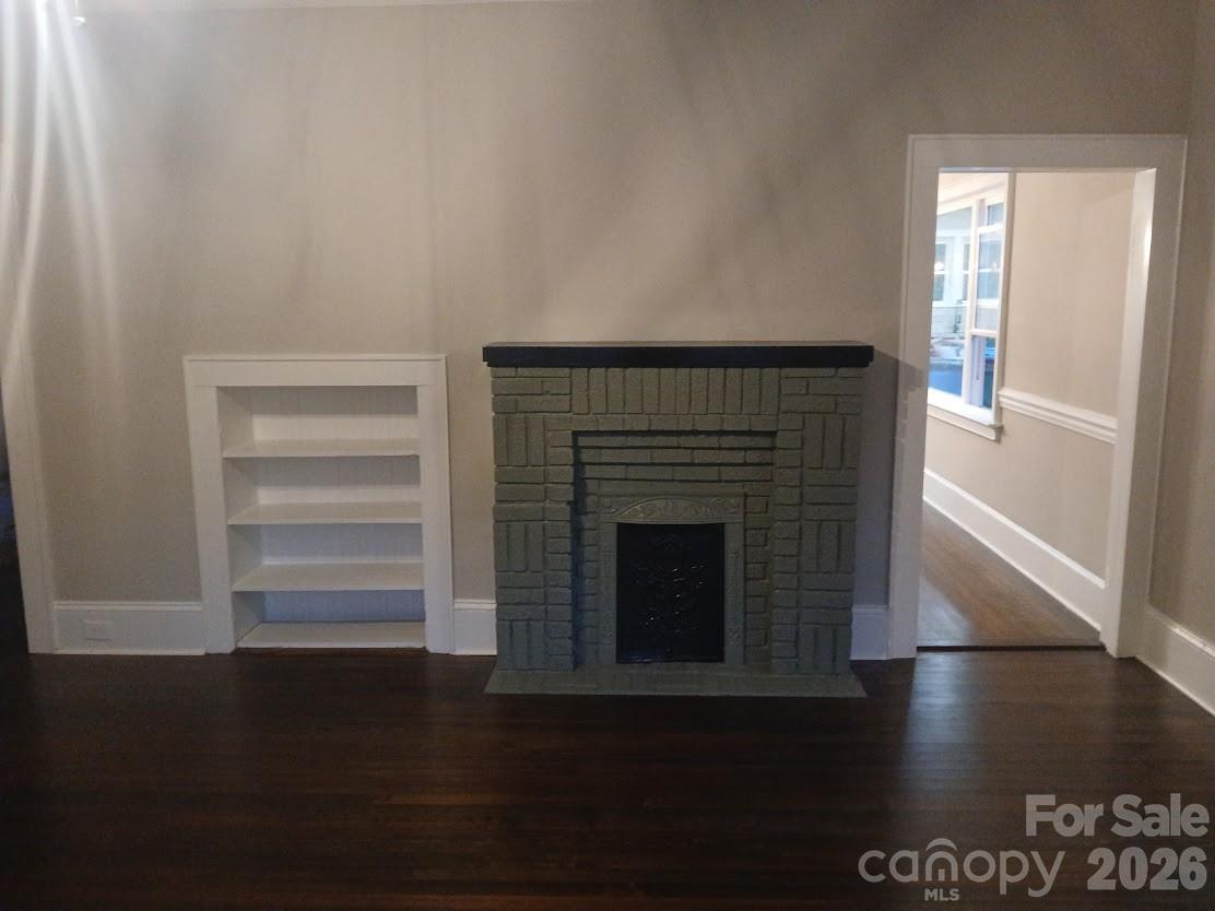 105 North Inman Avenue Bessemer City, NC 28016 - Photo 17 of 38 a living room with hard wood floors and a fireplace