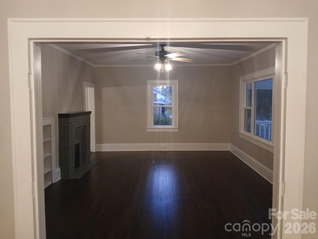 105 North Inman Avenue Bessemer City, NC 28016 - Photo 18 of 38 a view of empty room with wooden floor and fan
