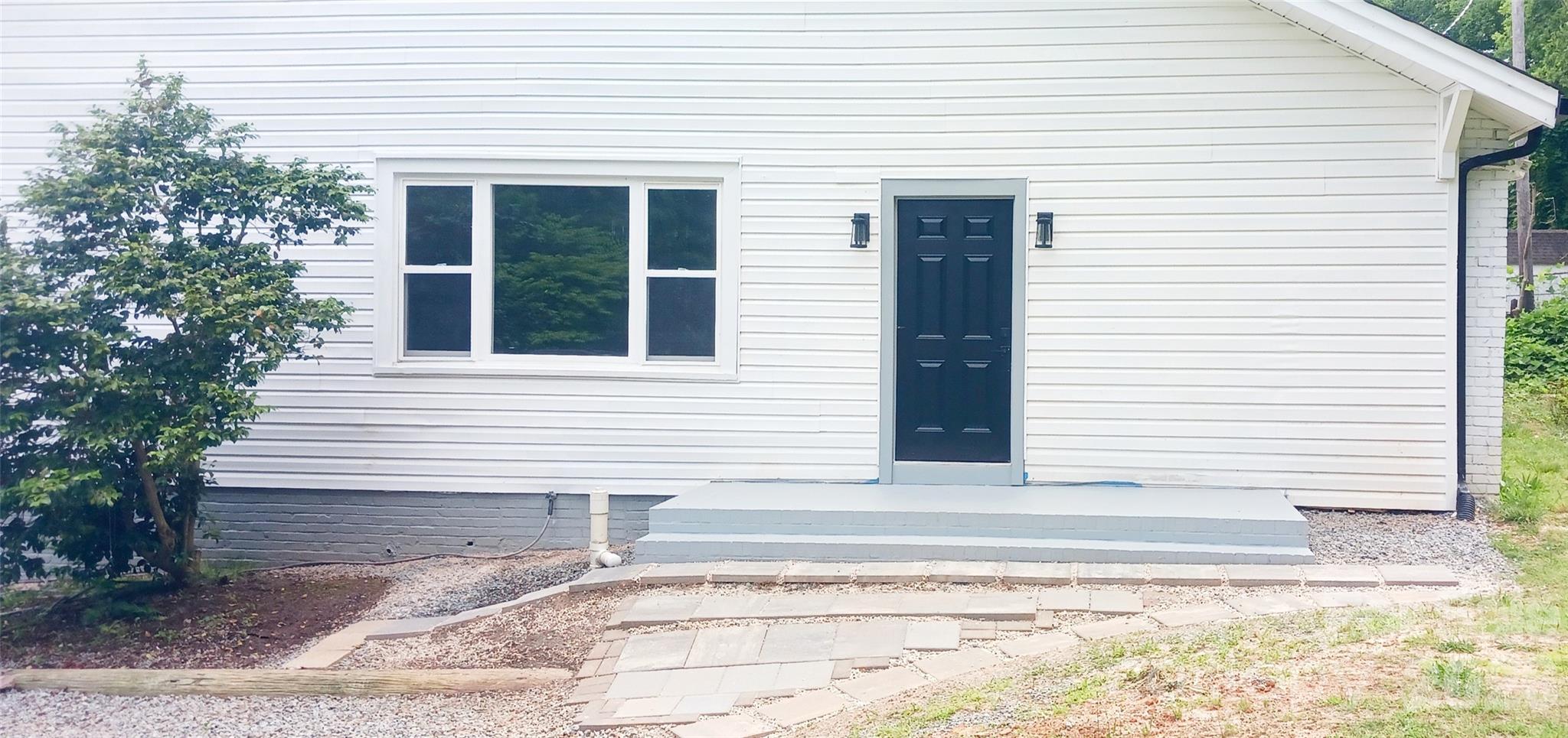 105 North Inman Avenue Bessemer City, NC 28016 - Photo 23 of 38 a white house with a outdoor space