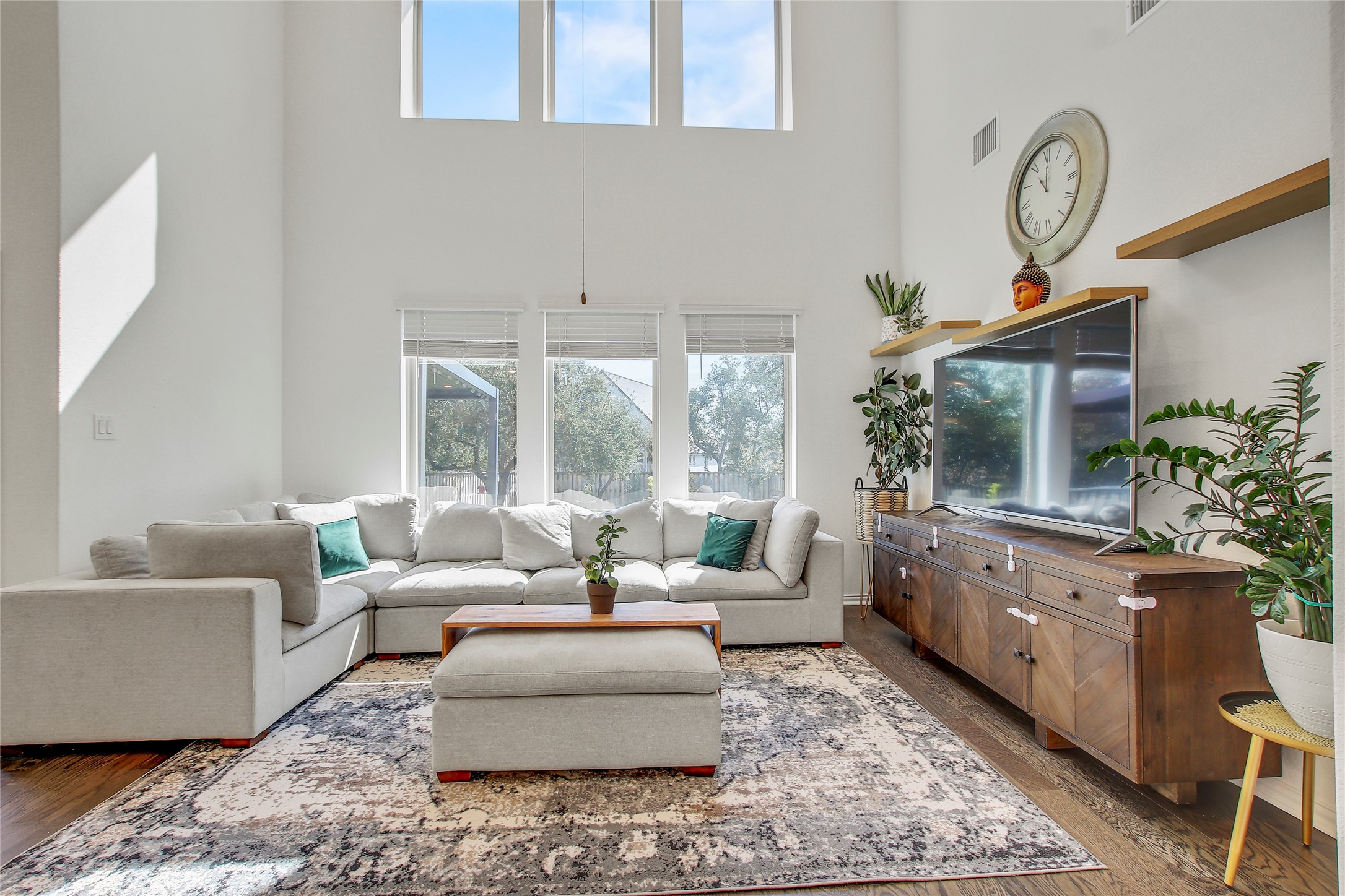 104 Millbend Road Georgetown, TX 78633 - Photo 15 of 40 Natural light floods this living space, highlighting high ceilings and rich hardwood floors.
