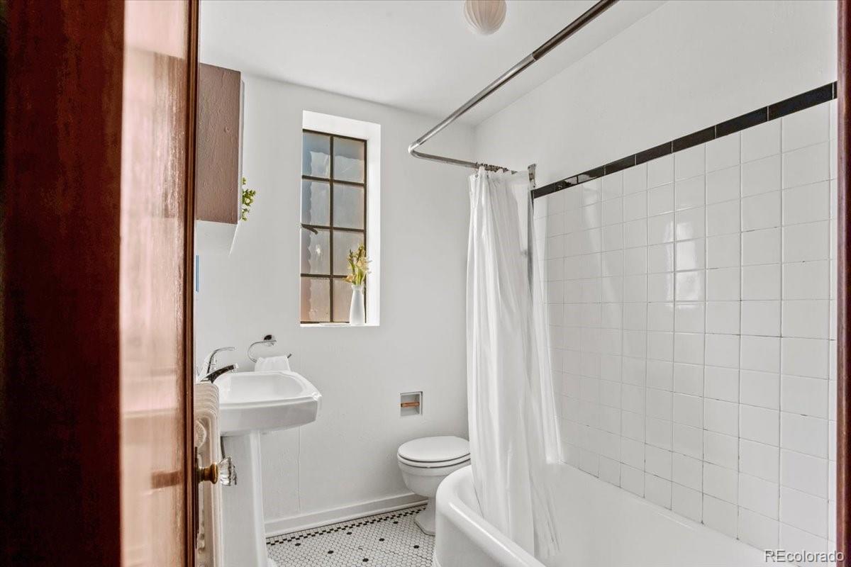 1575 Fillmore Street, Unit 6 Denver, CO 80206 - Photo 15 of 15 a bathroom with a granite countertop sink toilet and shower