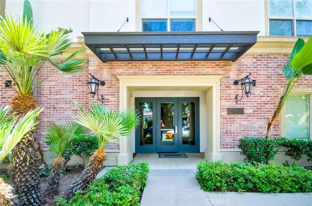 a front view of a house with potted plants
