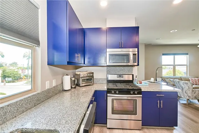 a kitchen with sink a stove and cabinets