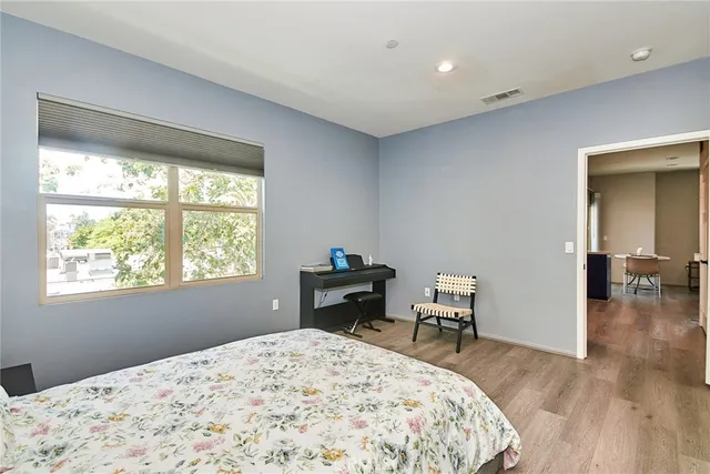a bedroom with a bed and wooden floor
