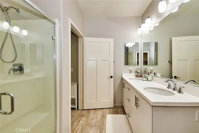 a bathroom with a double vanity sink a and mirror