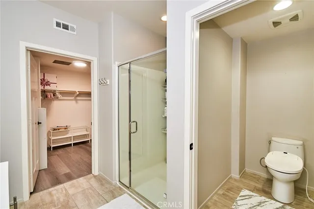 a bathroom with a toilet and a shower