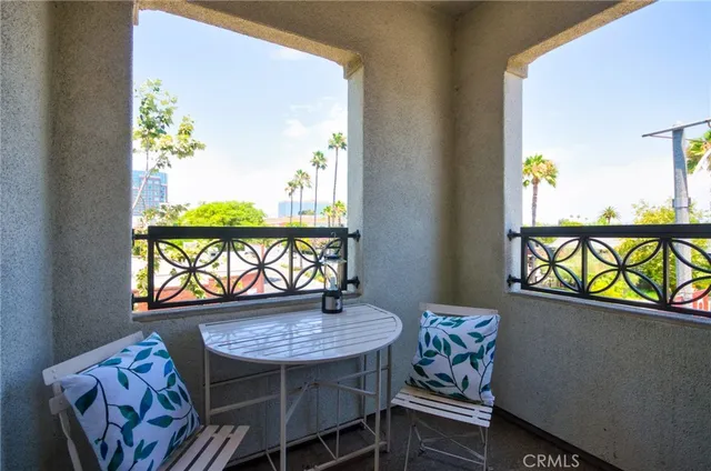 a view of a dining room with furniture a potted plant and a wooden floor