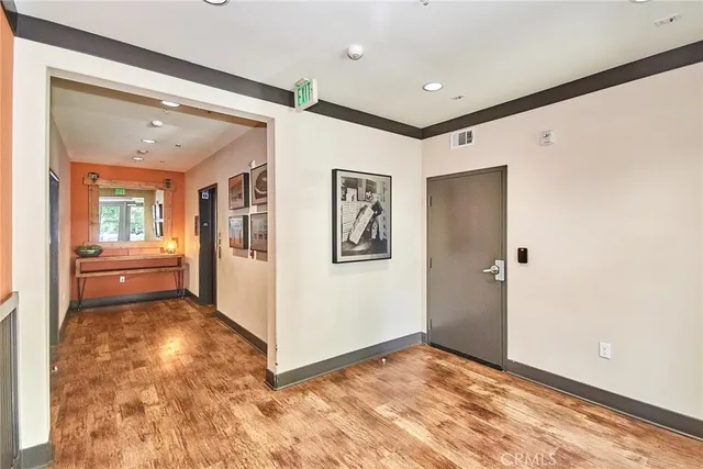 a view of a hallway with kitchen area and refrigerator