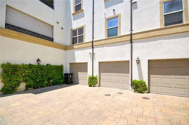 a front view of a building with potted plants