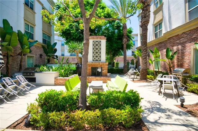 a view of a chair and tables in the patio in front of a building