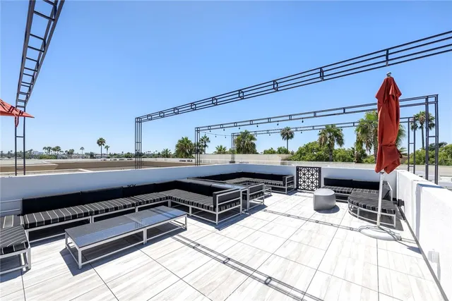 a roof deck with table and chairs