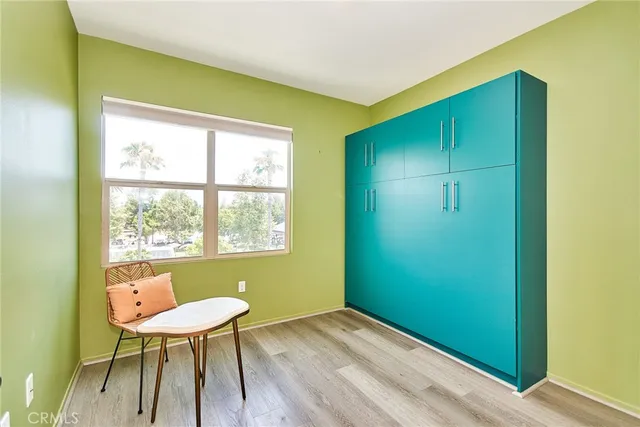 a view of a room that has a table chair and a window