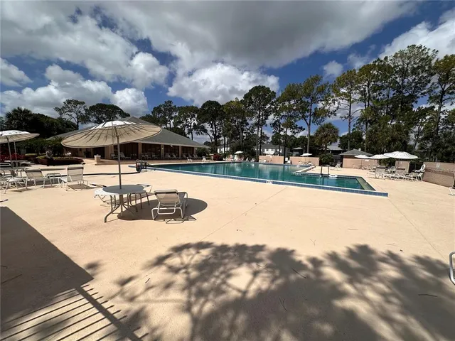 a view of a swimming pool with a table and chairs