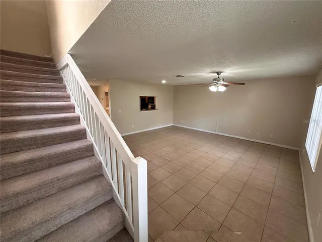 a view of an empty room with stairs